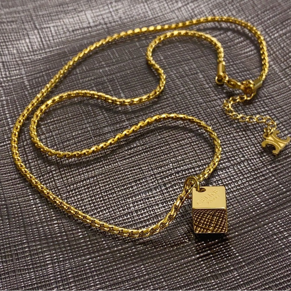 Celine's golden cup-shaped necklace
